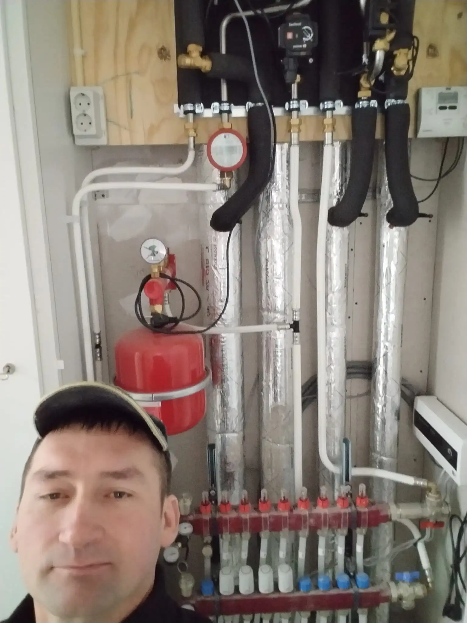 Service technician inspecting plumbing connections
